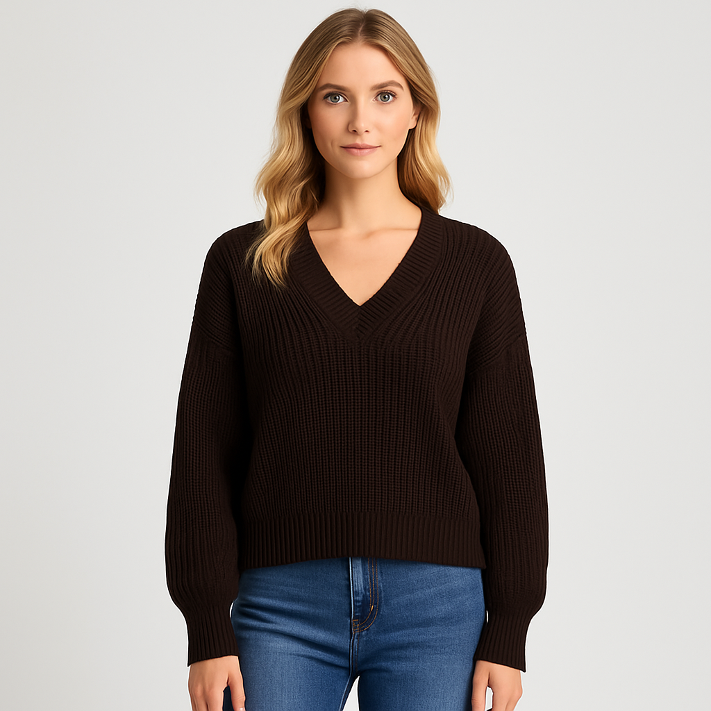 Ribbed knit sweater with deep V-neckline and relaxed fit, styled for chic casual wear