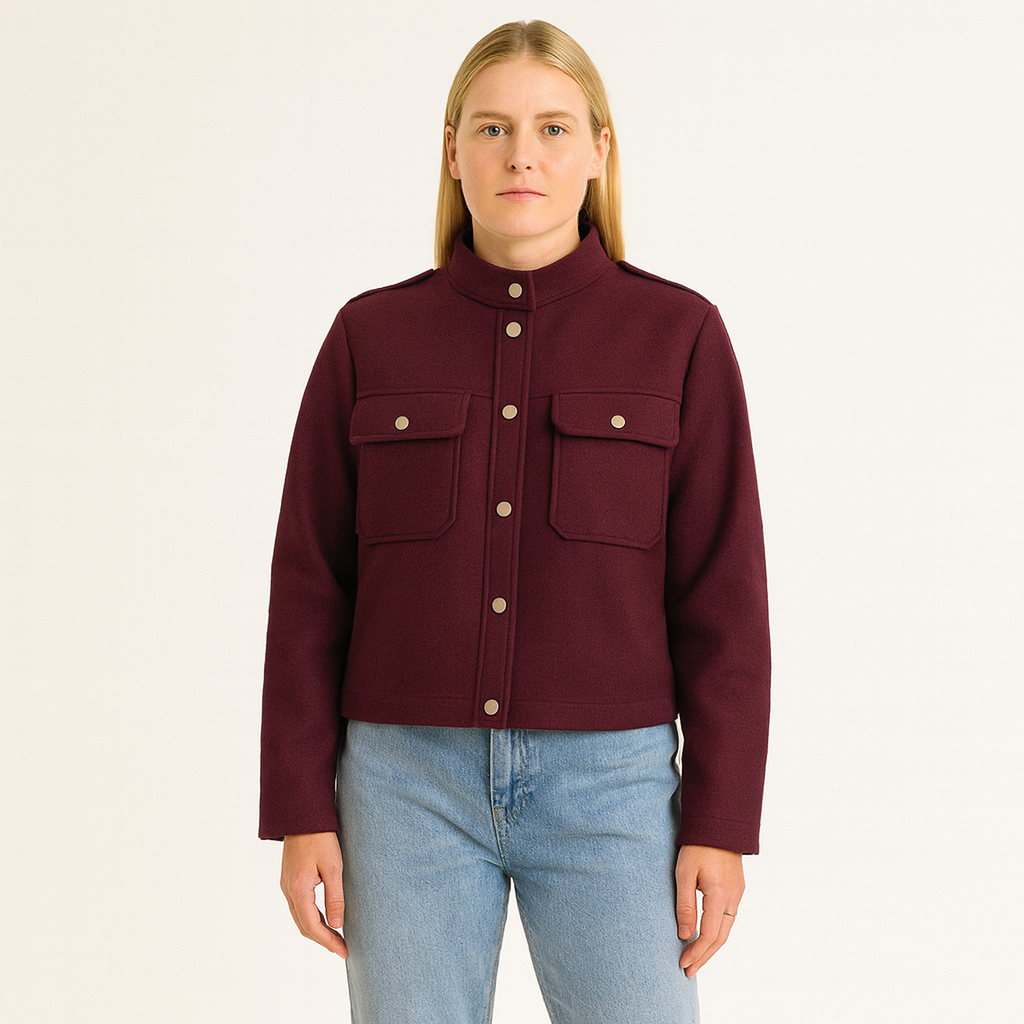 A short jacket with a stand collar, button-down front, long sleeves, and two front flap pockets.